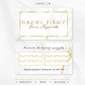 Projekt złoconego terminarzyka wizyt na białym marmurowym tle